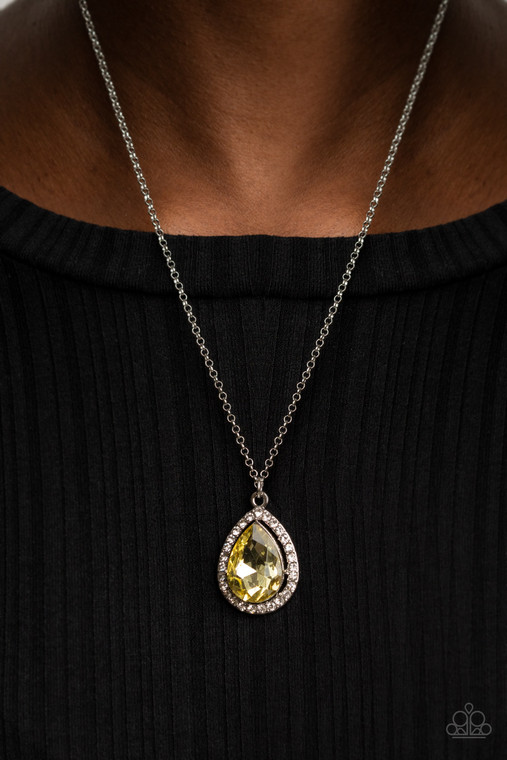 An oversized Illuminating rhinestone teardrop is pressed into the center of a silver frame bordered in white rhinestones, creating a glamorous pendant below the collar. Features an adjustable clasp closure.

Sold as one individual necklace. Includes one pair of matching earrings.