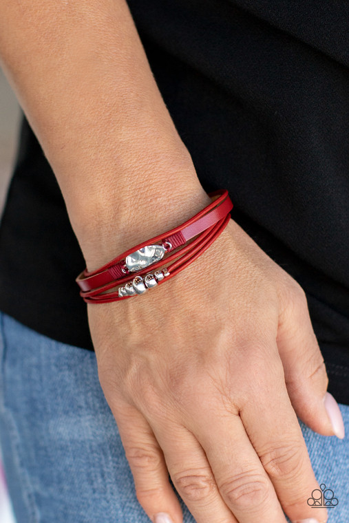 Infused with a silver beaded accent, rows of shiny red cording join a red leather band around the wrist. A hammered silver teardrop is knotted in place with red thread, adding an artisanal touch to the colorfully rustic centerpiece. Features a magnetic closure.

Sold as one individual bracelet.