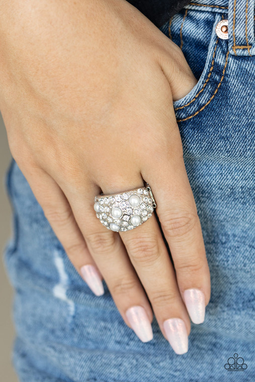 An explosion of dainty white rhinestones and bubbly white pearls are encrusted across the front of a thick silver band, creating a glamorous centerpiece atop the finger. Features a stretchy band for a flexible fit.

Sold as one individual ring.