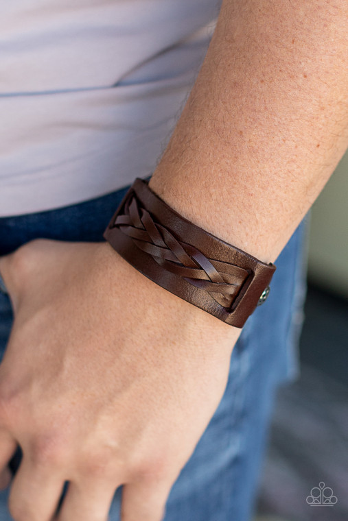 Braided strands of brown leather laces are studded in place across the front of a thick brown leather band with hammered silver studs, creating a rustic centerpiece around the wrist. Features an adjustable buckle closure.

Sold as one individual bracelet.