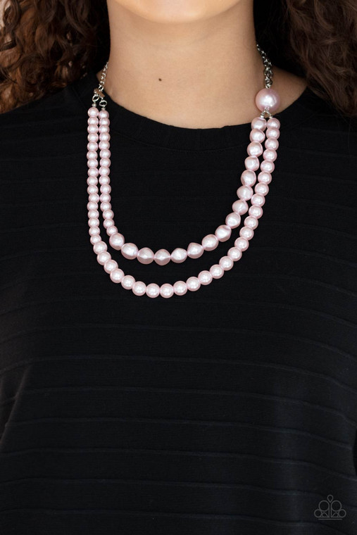 A dramatically oversized pink pearl gives way to two mismatched strands of classic pink pearls that graduate in size and imperfect finishes, adding a timeless twist to the classic pearl palette. Features an adjustable clasp closure.

Sold as one individual necklace. Includes one pair of matching earrings.