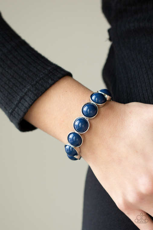 Featuring depthless blue beaded centers, bubbly silver frames are threaded along stretchy bands around the wrist for a powerful pop of color.

Sold as one individual bracelet.