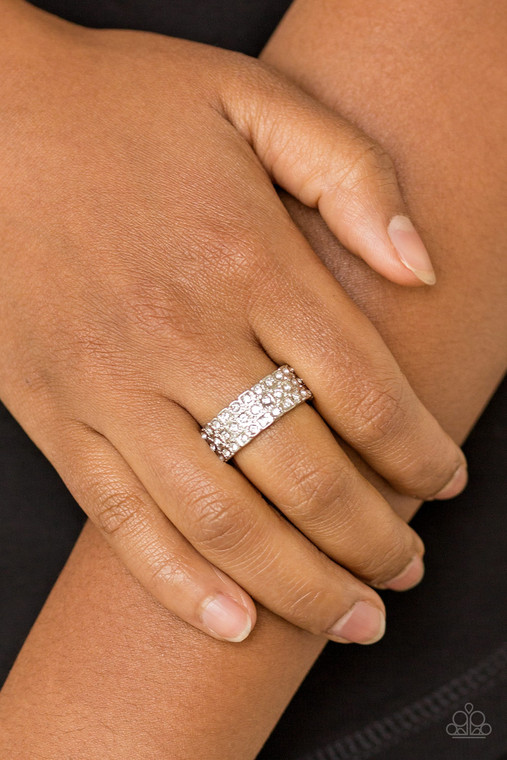 Row after row of dazzling white rhinestones are encrusted along a dainty silver band, creating timeless shimmer. Features a dainty stretchy band for a flexible fit.