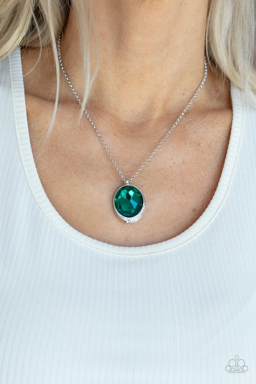 An oversized green gem is pressed into a sleek silver fitting dipped in dainty white rhinestones, creating a glamorous pendant at the bottom of a dainty silver chain. Features an adjustable clasp closure.

Sold as one individual necklace. Includes one pair of matching earrings.