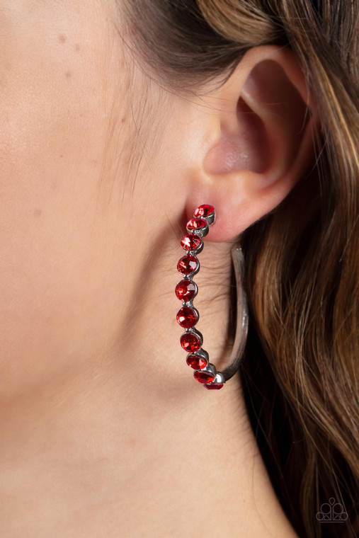 The front of a bold silver hoop is encrusted in fiery red rhinestones, creating a glamorous pop of sparkle. Earring attaches to a standard post fitting. Hoop measures approximately 1 3/4" in diameter.

Sold as one pair of hoop earrings.