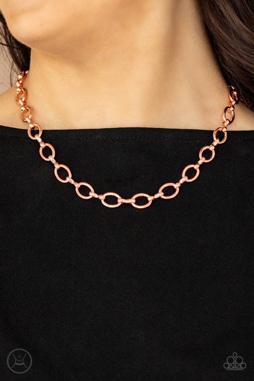 A collection of oversized shiny copper ovals and shiny copper fittings interlock around the neck, creating an intense industrial look. Features an adjustable clasp closure.

Sold as one individual choker necklace. Includes one pair of matching earrings.