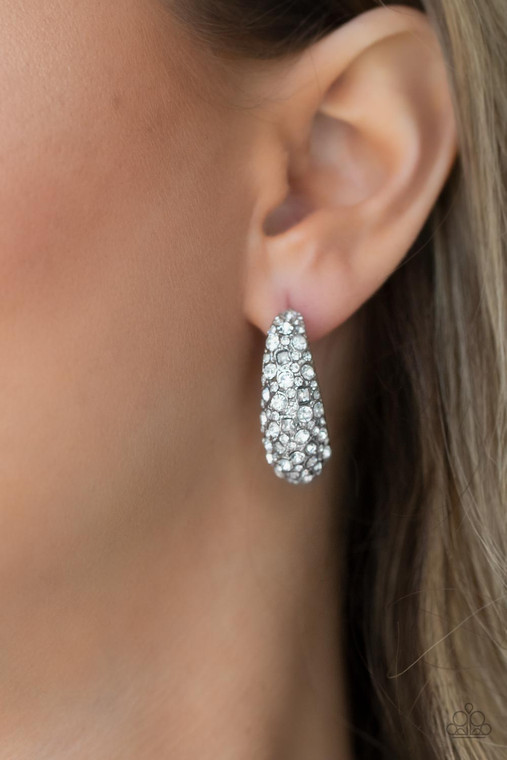 Featuring a beveled surface, a thick hammered silver hoop is haphazardly encrusted in round and square white rhinestones for a glamorously glittery finish. Earring attaches to a standard post fitting. Hoop measures approximately 3/4" in diameter.

Sold as one pair of hoop earrings.