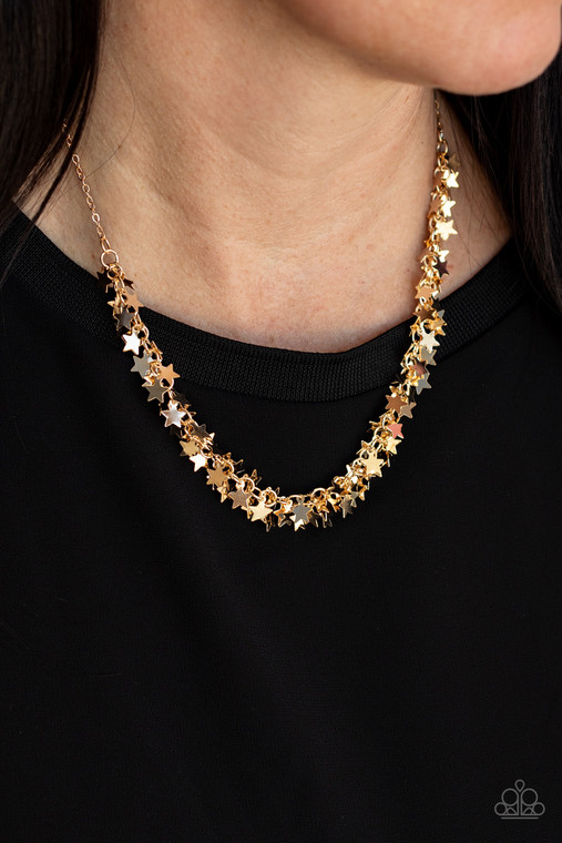 A glistening collection of dainty gold star charms delicately cluster on a classic gold chain, creating a stellar fringe below the collar. Features an adjustable clasp closure.

Sold as one individual necklace. Includes one pair of matching earrings.