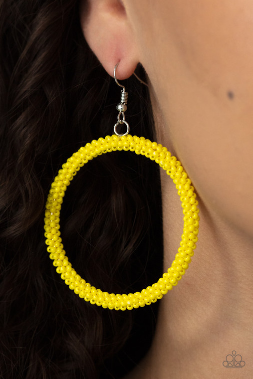 A dainty strand of Illuminating seed beads wrap around a silver hoop, creating a bubbly hoop. Earring attaches to a standard fishhook fitting.

Sold as one pair of earrings.