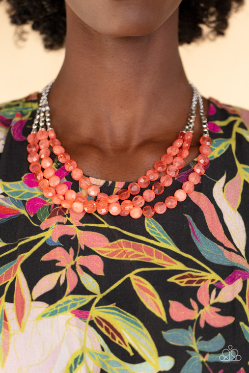 Threaded along invisible wires, rows of faceted silver beads give way to opaque coral gem-like beads below the collar for a summery splash of color. Features an adjustable clasp closure.

Sold as one individual necklace. Includes one pair of matching earrings.