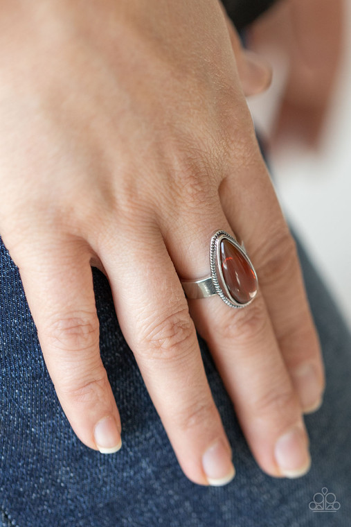 Featuring a glassy iridescence, a brown teardrop acrylic bead is pressed into the center of studded silver fittings, creating a mystical centerpiece atop the finger. Features a dainty stretchy band for a flexible fit.

Sold as one individual ring.