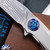 Skiff Made Blades Fugitive, Damasteel (Fafnir Pattern) Blade, Milled Titanium Scales, Royal Blue Ti Backspacer, Black Timascus Pivot Collar and Clip,  #100