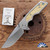 Attn 2 Detail Mark 3 Medium, Magnacut Drop Point Blade, Titanium Handle With Archer Pattern Brass Inlay