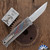 Reate EXO-M Gravity Knife, Satin Elmax Drop Point Blade, Bead Blast Titanium, Multi-Color G10 Damascus Pattern Inlay