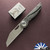 Hypercut Manufacturing Cretin, Dark Stonewashed S45VN Blade, Carbon Fiber Handle Scales W/Zirc Pivot And Black Timascus Pivot Collars