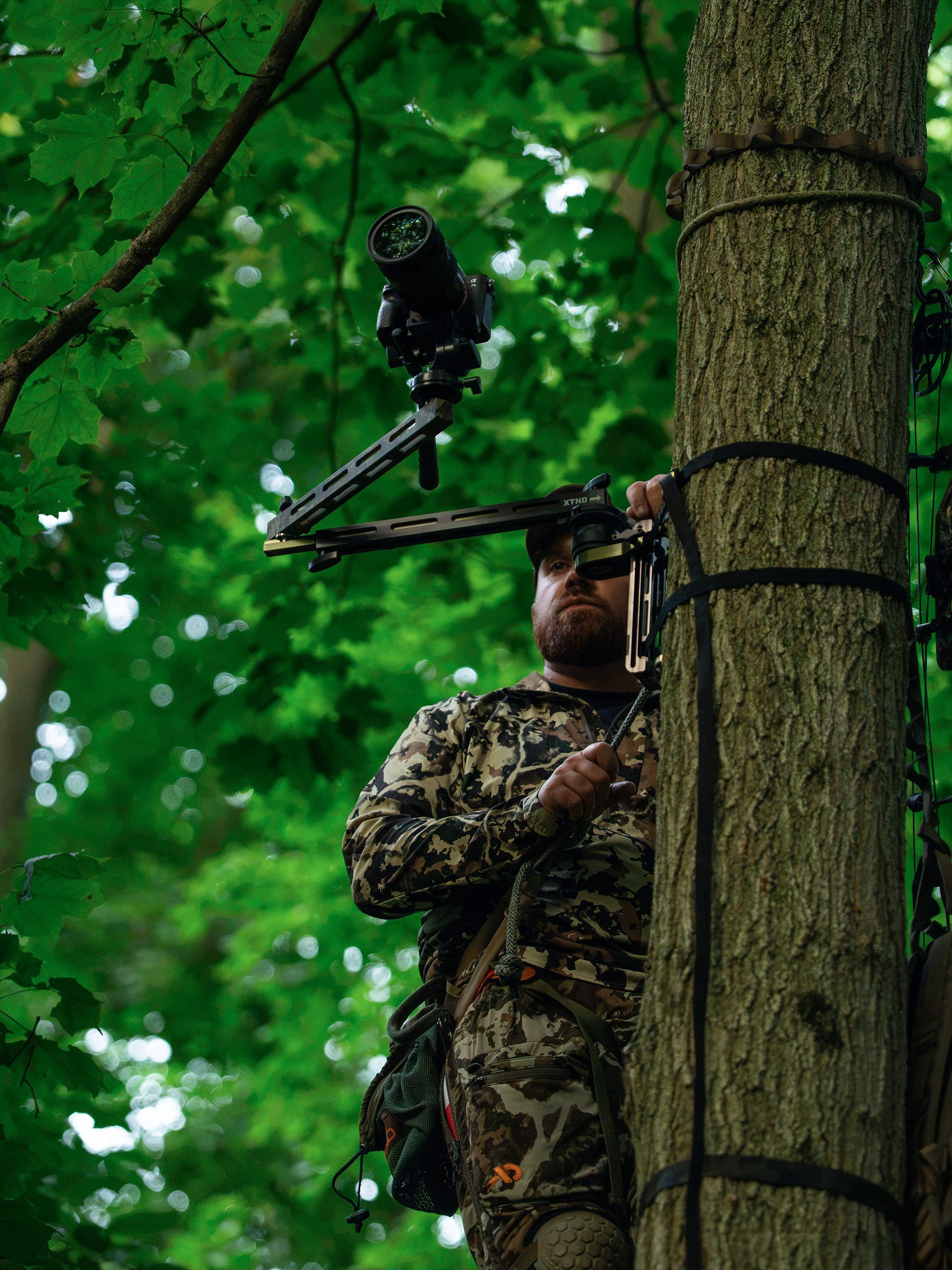 Hunter filming from a treestand with the Ambush Camera Arm overhead