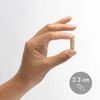 Hand holding a 2.3 cm capsule