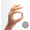 Hand holding a Pau D'Arco capsule shown at 2.5 cm for size reference