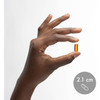 Hand holding a Vitamin E softgel shown at 2.1 cm for size reference