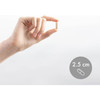 Hand holding a Calcium with Vitamins D3 & K2 capsule shown at 2.5 cm for size reference