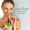 Woman sipping a green drink through a straw, juiced greens graphic
