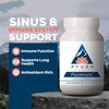 Flucomune bottle on a rock with immune and antioxidant-rich feature icons