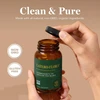 Hands opening Latero-Flora bottle, clean and pure with non-GMO and gluten-free icons