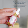 Hand holding Castor Serum dropper bottle, for luscious lashes and bold brows