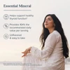 Woman sitting by a window, essential mineral graphic with unflavored, easy to take icons