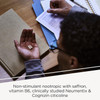 Person holding capsules at a desk, saffron, vitamin B6, Neumentix and Cognizin graphic