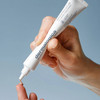 Hand dispensing Dermalogica Skin Perfect Primer onto fingertip