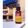 Herb Pharm Holy Basil bottle on a desk near a laptop