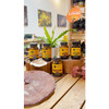 Everyday 10 bottles on a wooden store counter with plants
