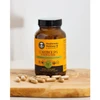 Cordyceps Blend bottle on a cutting board with loose capsules