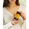 Woman holding a Cordyceps Blend capsules bottle against her chest