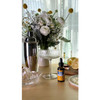 Herb Pharm Lemon Balm bottle on a table with lemons, flowers and glassware