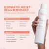 Hand holding Avène Thermal Spring Water with dermatologist recommended uses list