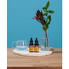 Two Herb Pharm dropper bottles beside a glass of water and a vase