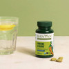 Immune Strong bottle beside lemon water and two tablets