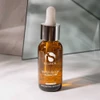 iS Clinical Super Serum Advance+ bottle on stone surface with glass backdrop