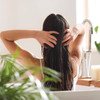 Woman running her hands through long dark hair
