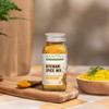 Kitchari Spice Mix jar beside bowls of spices and prepared kitchari