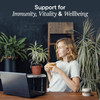 Woman at a desk with plants, immunity vitality and wellbeing graphic