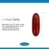 Single dark red softgel beside a ruler, 1 softgel daily