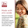 Smiling woman with made with zinc oxide mineral text