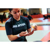 Woman in a jiu jitsu shirt applying Active Skin Repair to her hand