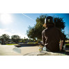 Child in a helmet sitting at a skate park
