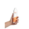 Hand holding Hydrating Serum bottle