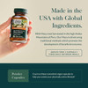 Hand holding the bottle, made in the USA with global ingredients graphic