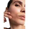 Woman lifting her cheek with her fingers